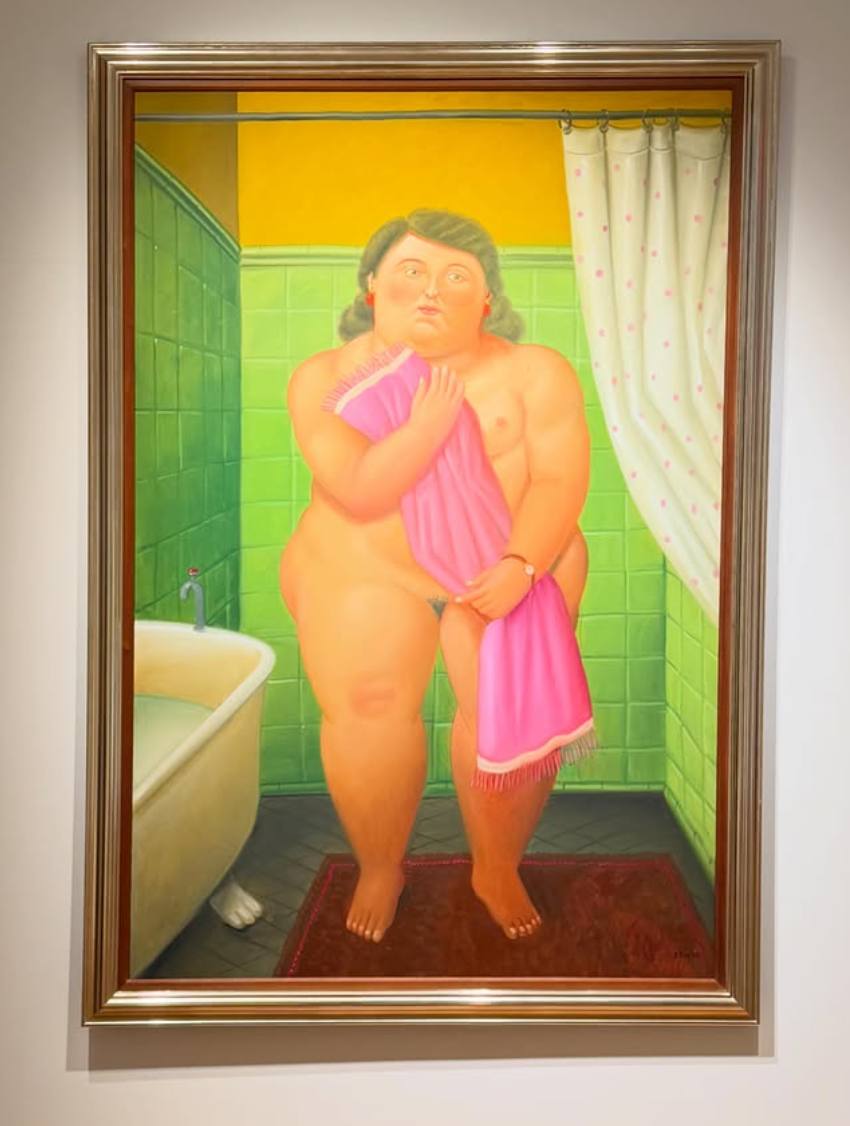 Fernando Botero painting of a full bodied woman standing on a small red rug in a green tiled bathroom, holding a pink towel, beside a white claw foot tub