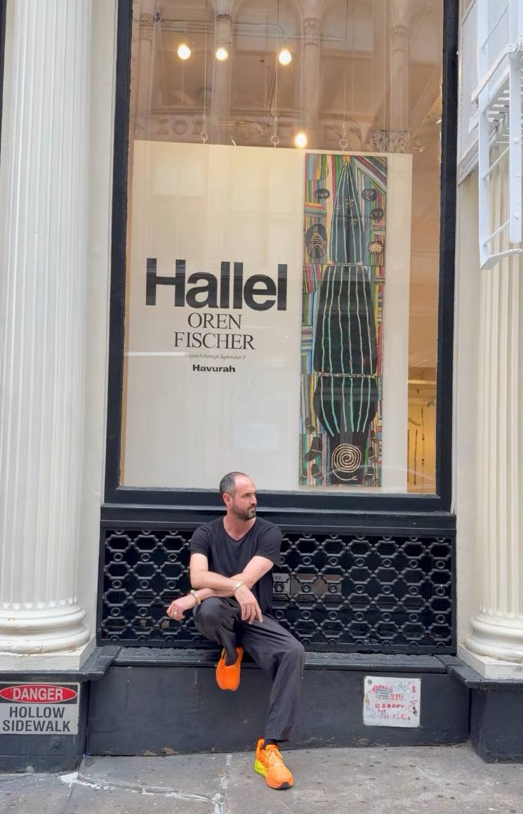 Storefront window of 81 Leonard Gallery in Tribeca, New York, showing a large poster that reads Hallel, Oren Fischer, Havurah, August 6 through September 5, with the artist seated on the sidewalk ledge below