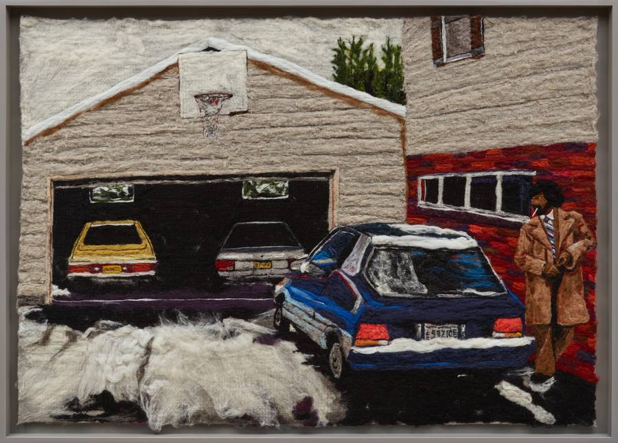 Melissa Joseph needle felted wool picture of a suburban driveway, three parked cars, a basketball hoop on the garage, and a man in a tan coat smoking a cigarette by a red brick wall, the whole scene built from soft wool fibers