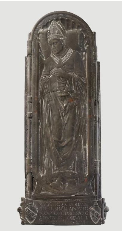 Bronze funerary monument showing a bishop in a mitre lying in relief on an arched slab, hands folded, with an inscription and two coats of arms at the base