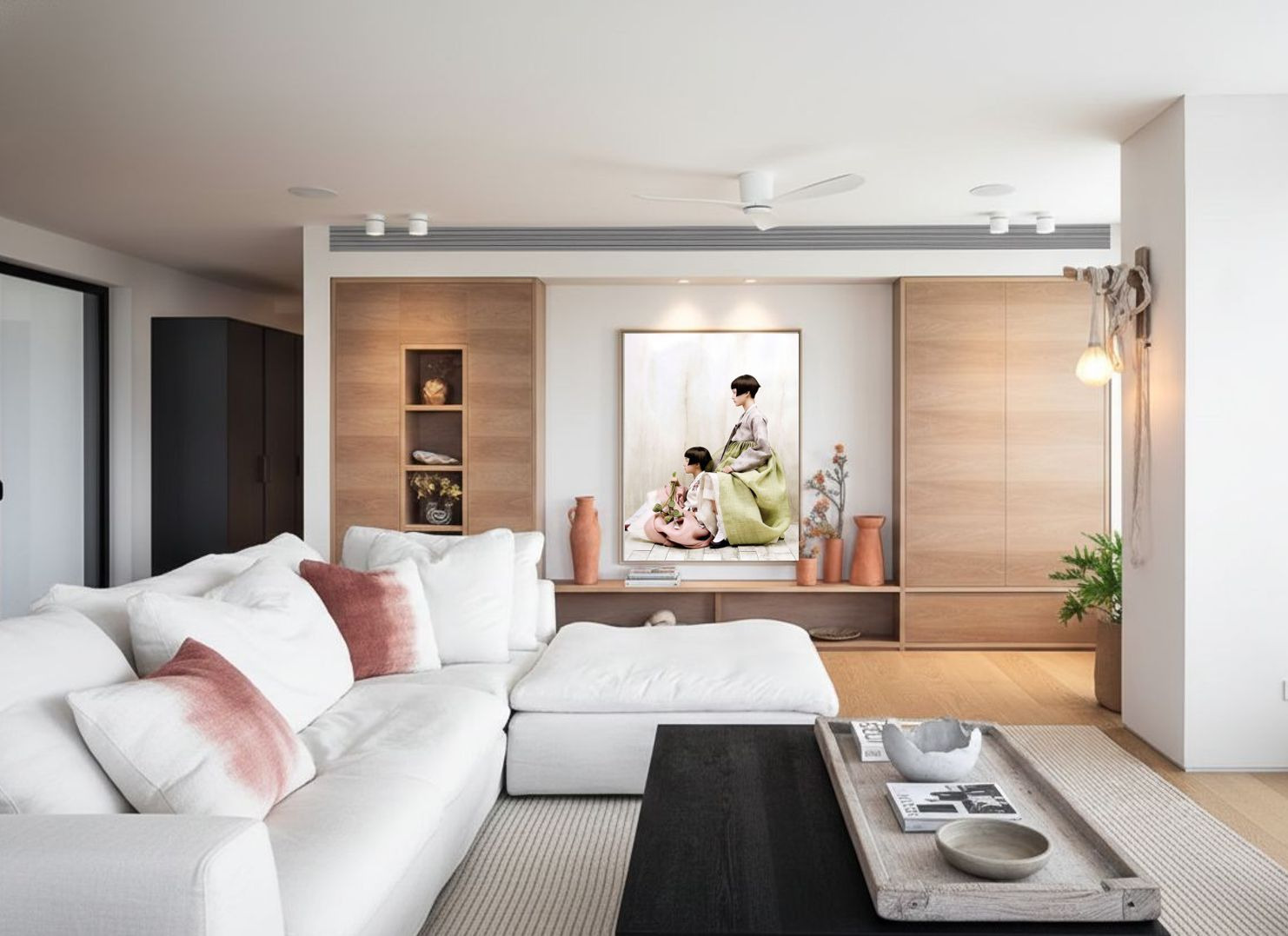 Living room in a Ramat Gan private home: white sofa, oak cabinetry, and a large format photograph of two figures in green and pink ceremonial dress on the central wall
